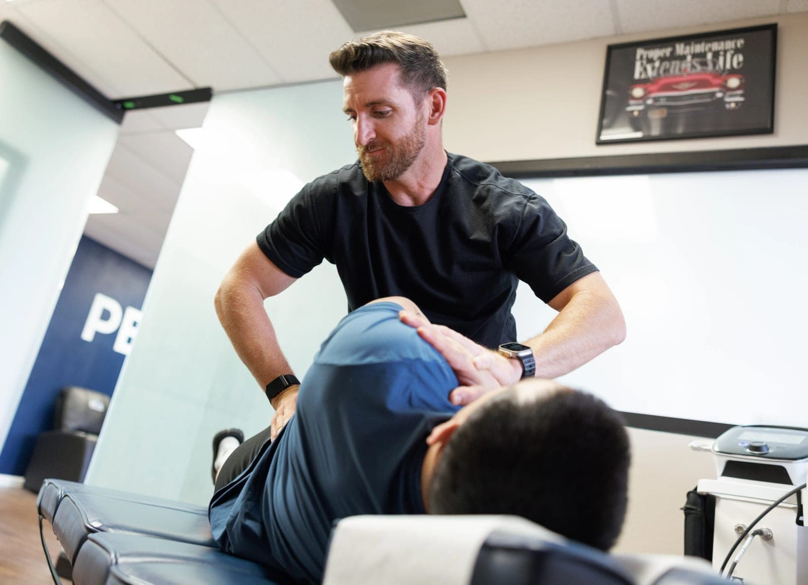 Dr. Charlie Brennan performing an adjustment in the Peak treatment room
