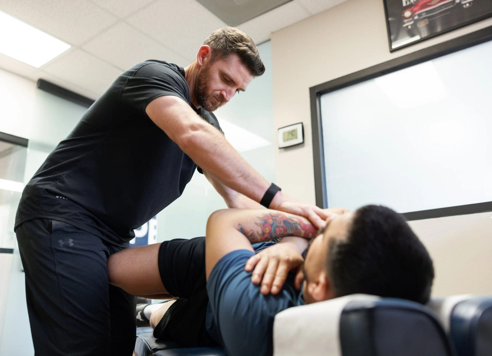 Dr. Brennan performing a side-posture adjustment on a patient