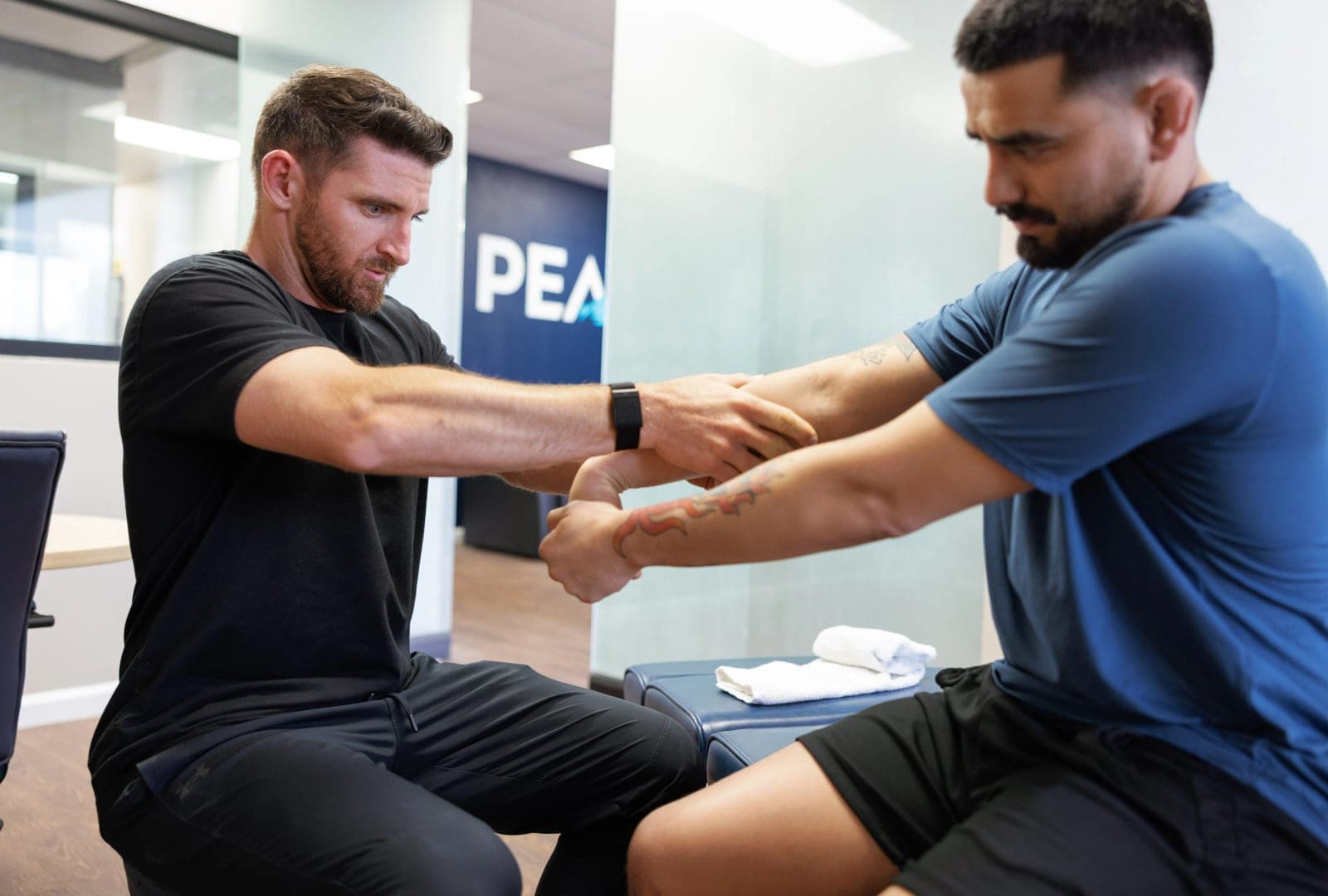 Dr. Brennan working through an Active Release Technique arm stretch with a patient