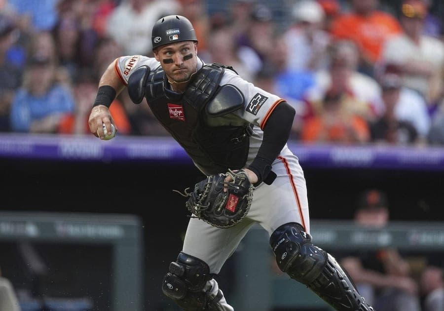 Andrew Knizner coming out of the crouch to throw in San Francisco Giants away grey