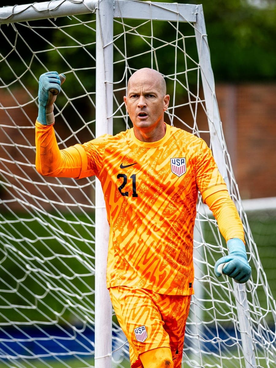 Bonner Paddock Rinn in a USA goalkeeper kit calling his line forward in front of the goal